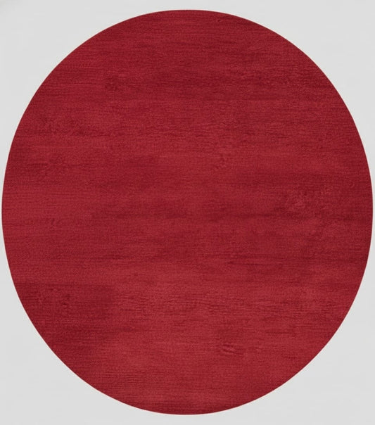 Crimson red round hand-loom carpet made from premium New Zealand wool on neutral background
