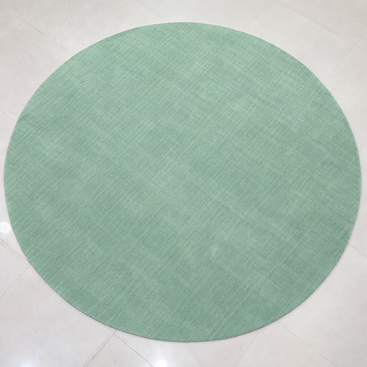 Sage green round hand-loom carpet crafted from premium New Zealand wool on tiled floor